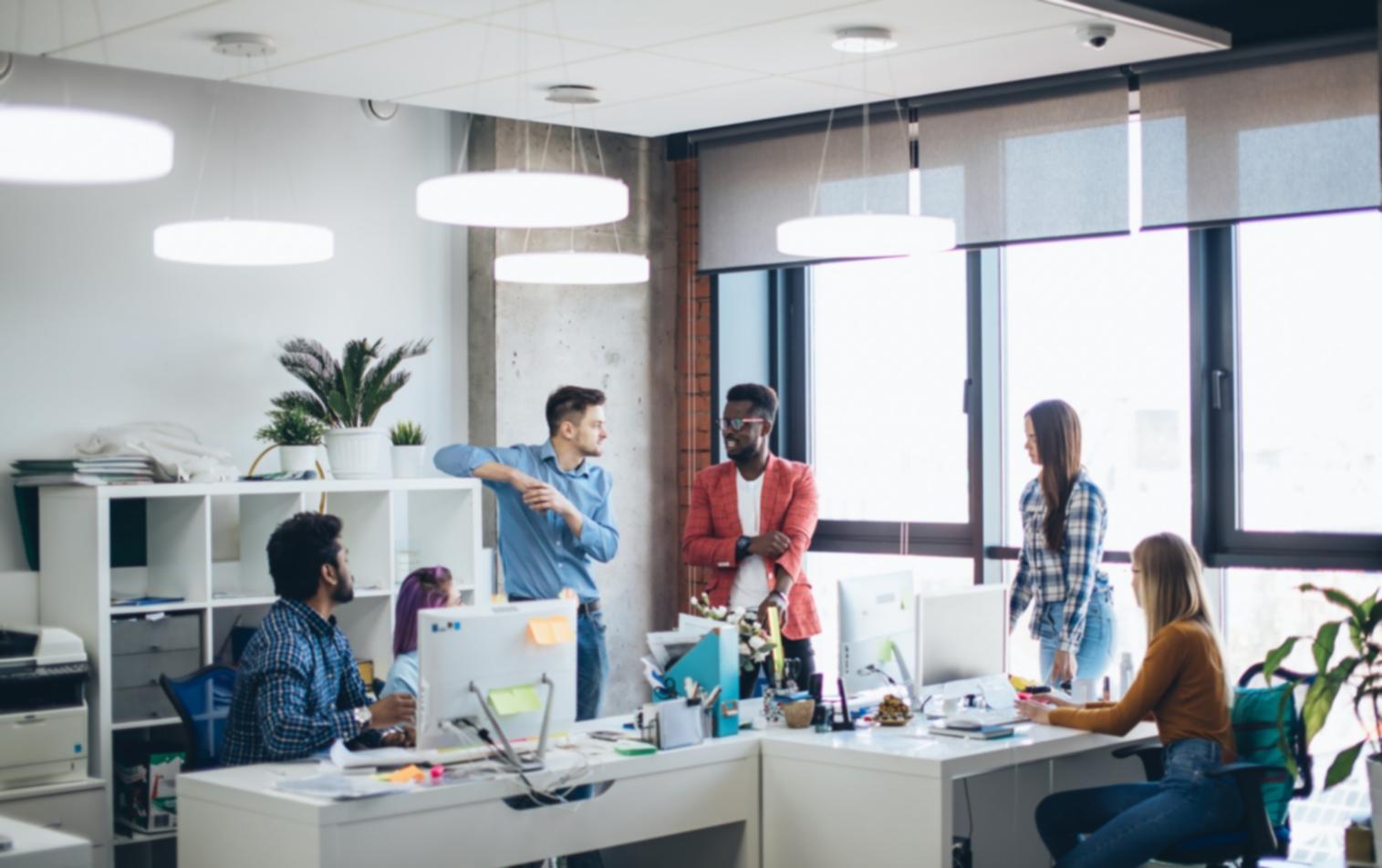 Developer reviewing game prototype layouts on multiple mobile devices